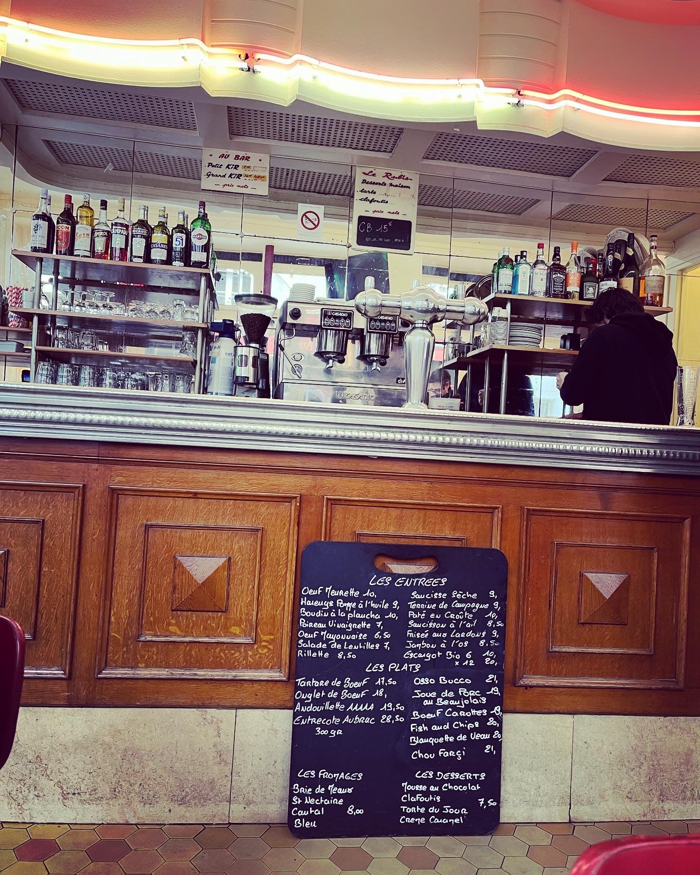 Bar counter with a menu board in a cozy bar setting
